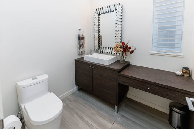 Bright bathroom with dark wood vanity and modern mirror. - Address WITHHELD, North Vancouver