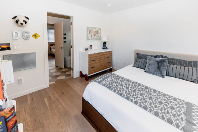 Spacious bedroom with hardwood floors and a cozy bed setup. - Address WITHHELD, North Vancouver