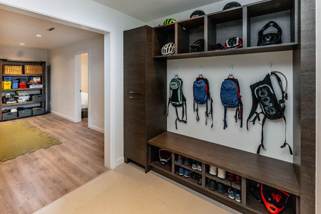 Furnished mudroom with shelves, backpacks, and helmets. - Address WITHHELD, North Vancouver