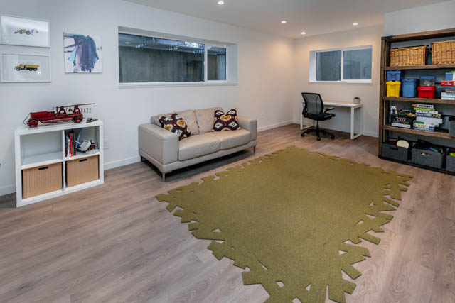 Furnished living room with hardwood floors, a sofa, and a desk. - Address WITHHELD, North Vancouver