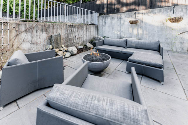 Furnished patio with modern sectional sofa and fire pit, perfect for relaxation. - Address WITHHELD, North Vancouver