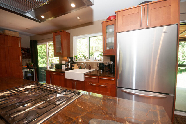 Modern kitchen with granite countertops and stainless steel appliances, perfect for cooking and entertaining.