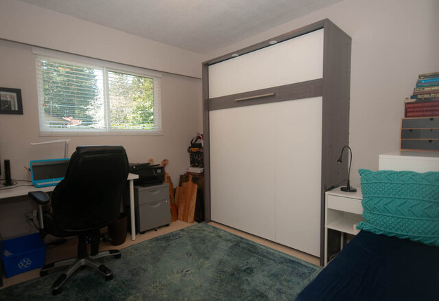 Shared bedroom with Murphy bed, desk, and window view. - Upper - 2352 Riverbank Pl, North Vancouver