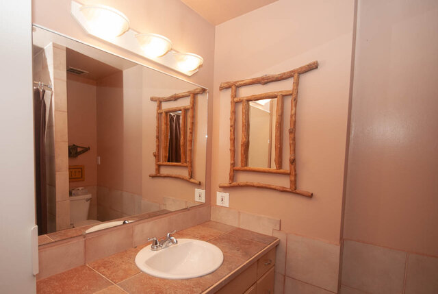 Bathroom with rustic wooden mirrors and terracotta countertops. - Upper - 2352 Riverbank Pl, North Vancouver