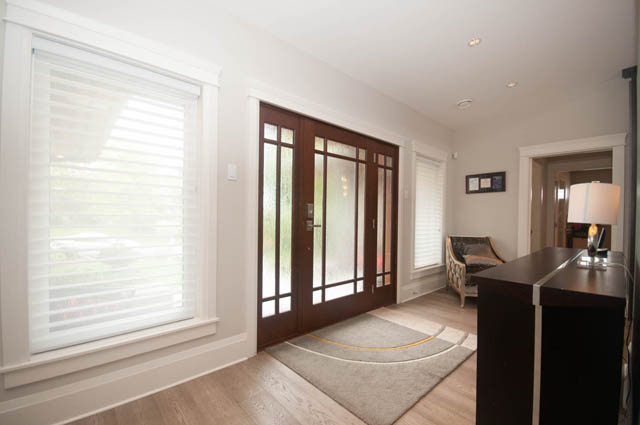 Bright living room with hardwood floors and large windows. - Upper - 876 48th Ave, Vancouver West Side