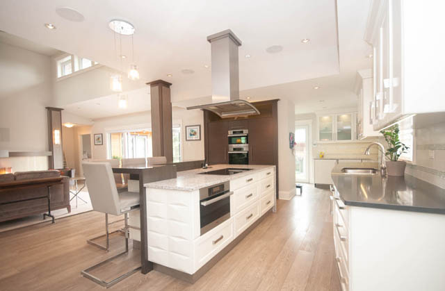 Bright kitchen with white cabinets, granite countertops, and hardwood floors. - Upper - 876 48th Ave, Vancouver West Side