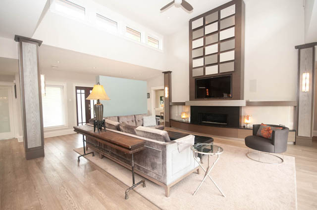 Spacious living room with hardwood floors, modern fireplace, and large windows. - Upper - 876 48th Ave, Vancouver West Side