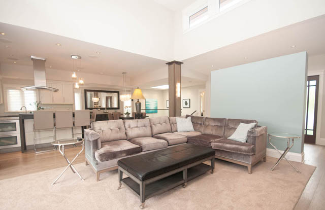 Spacious living room with hardwood floors and modern furniture. - Upper - 876 48th Ave, Vancouver West Side