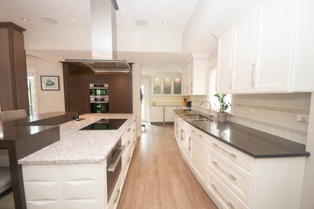 Bright kitchen with white cabinets, granite countertops, and hardwood floors. - Upper - 876 48th Ave, Vancouver West Side