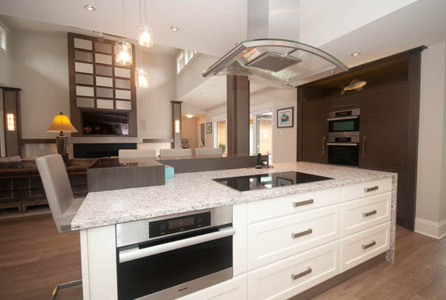 Bright kitchen with granite countertops, hardwood floors, and a modern island. - Upper - 876 48th Ave, Vancouver West Side