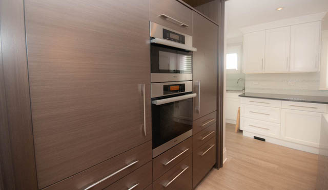 Bright kitchen with modern appliances, hardwood floors, and white cabinetry. - Upper - 876 48th Ave, Vancouver West Side