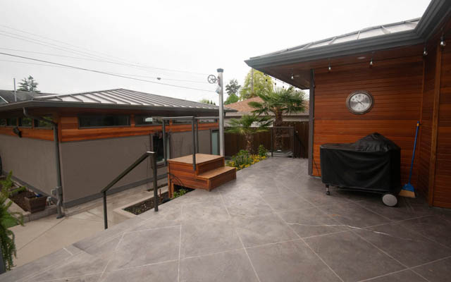 Furnished patio with wooden deck and covered grill. - Upper - 876 48th Ave, Vancouver West Side