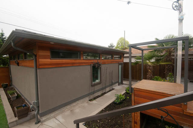 Furnished living room with modern wood accents and large windows. - Upper - 876 48th Ave, Vancouver West Side