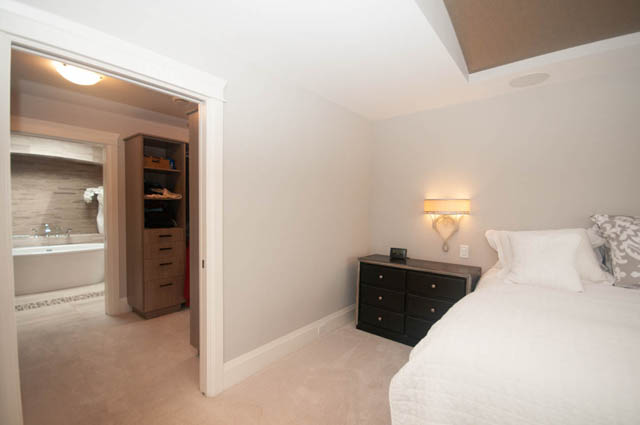 Bright bedroom with white bedding and built-in closet, clean and tidy. - Upper - 876 48th Ave, Vancouver West Side