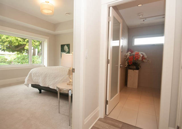 Bright living room with large windows and a cozy corner setup. - Upper - 876 48th Ave, Vancouver West Side