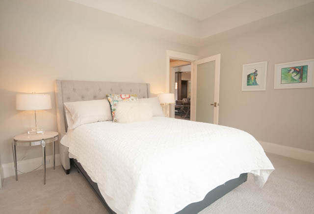 Spacious bedroom with white bedding and modern decor. - Upper - 876 48th Ave, Vancouver West Side