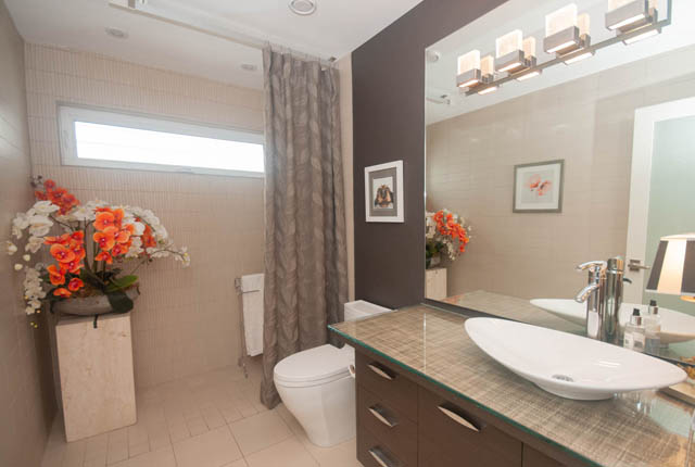 Bright bathroom with modern sink, glass countertop, and large mirror. - Upper - 876 48th Ave, Vancouver West Side