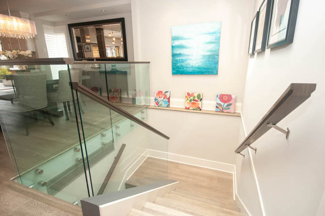 Staircase leading to upper level with modern railings and artwork. - Upper - 876 48th Ave, Vancouver West Side