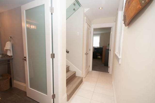 Furnished hallway with tiled floors and a glass door leading to a bathroom. - Upper - 876 48th Ave, Vancouver West Side