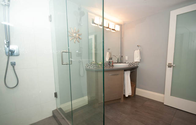 Bright bathroom with glass shower and modern sink. - Upper - 876 48th Ave, Vancouver West Side