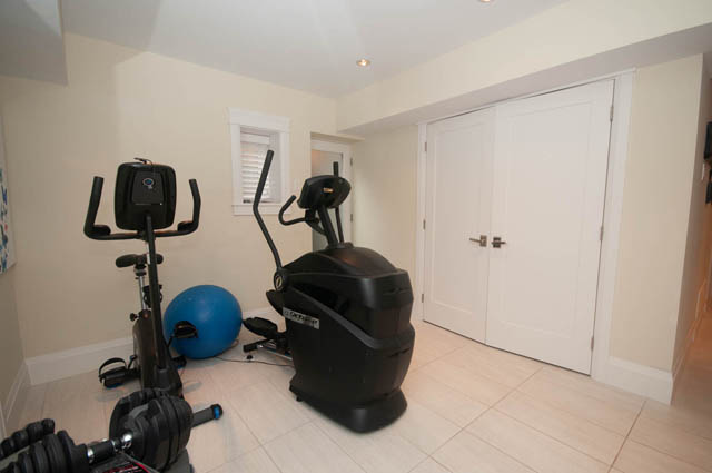 Fitness room with exercise equipment and wooden flooring. - Upper - 876 48th Ave, Vancouver West Side