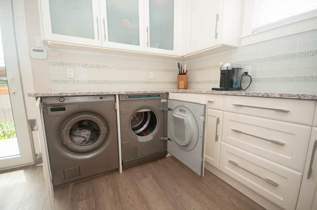 Shared laundry room with granite countertops and white cabinets. - Upper - 876 48th Ave, Vancouver West Side