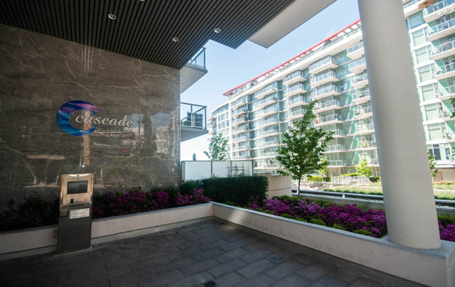 Furnished living room with modern decor and city view. - 404 - 185 Victory Ship Way, North Vancouver