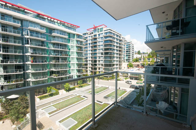 Bright living room with city view and modern furnishings. - 404 - 185 Victory Ship Way, North Vancouver