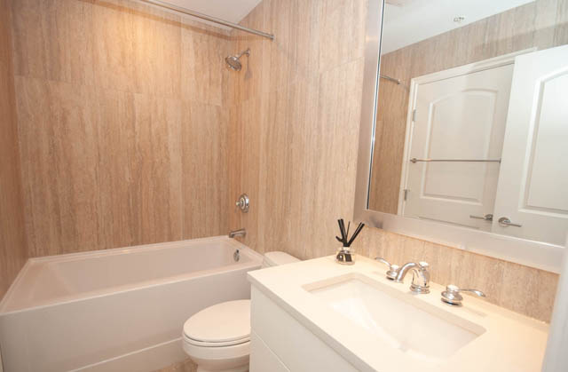 Furnished bathroom with wooden walls and modern fixtures. - 404 - 185 Victory Ship Way, North Vancouver