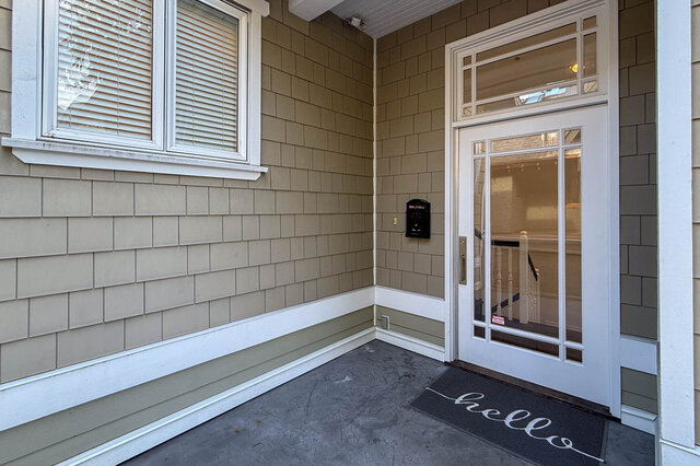Entryway with glass-paneled door and "hello" doormat, showcasing the home. - 2307 Marine Drive, West Vancouver
