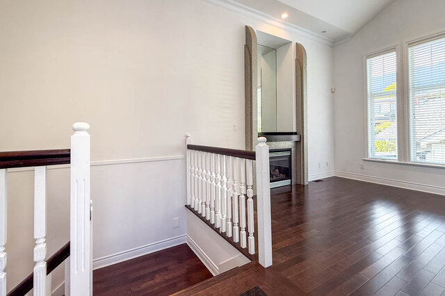 Spacious living room with hardwood floors and arched fireplace view. - 2307 Marine Drive, West Vancouver