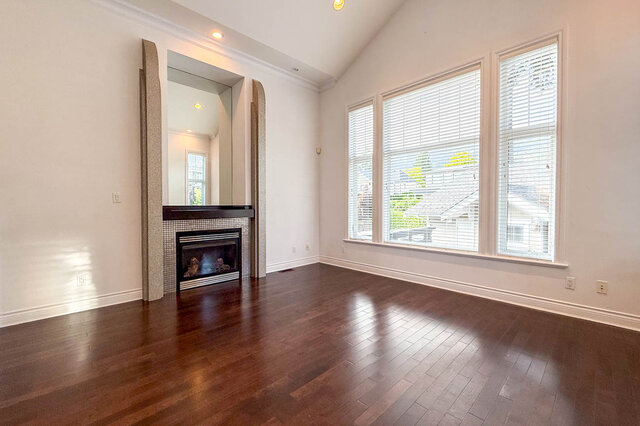 Spacious living room with hardwood floors and fireplace tile surround. - 2307 Marine Drive, West Vancouver