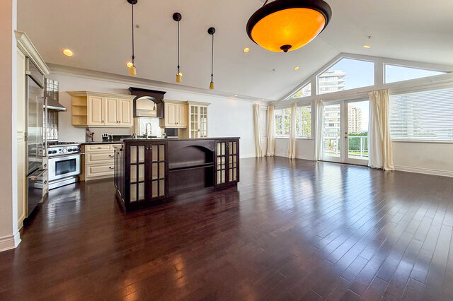 Spacious kitchen with dark hardwood floors and city view through large windows. - 2307 Marine Drive, West Vancouver
