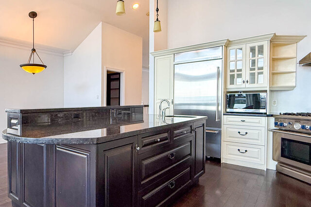 Bright kitchen with dark granite countertops and rich hardwood floors. - 2307 Marine Drive, West Vancouver