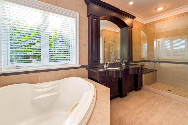 Bright bathroom with granite countertops and a white whirlpool tub. - 2307 Marine Drive, West Vancouver