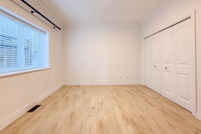 Bright bedroom with large window and light hardwood floors. - 2307 Marine Drive, West Vancouver