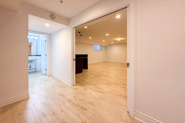 Spacious living area with light hardwood floors and grand piano. - 2307 Marine Drive, West Vancouver