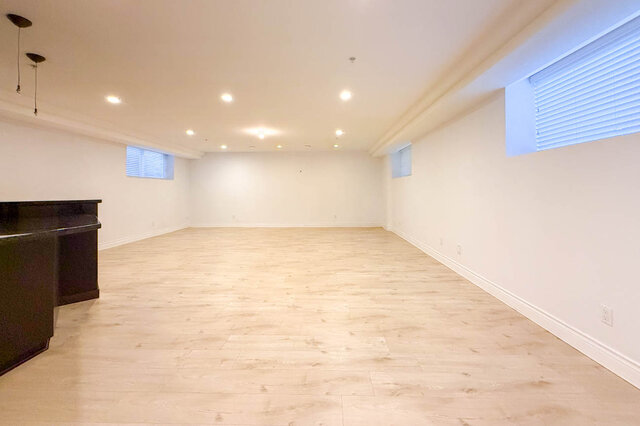 Spacious living room with light hardwood floors and a dark grand piano. - 2307 Marine Drive, West Vancouver