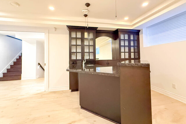 Bright kitchen with dark island, granite countertops, and light. - 2307 Marine Drive, West Vancouver