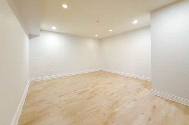 Spacious bedroom with light hardwood floors and recessed ceiling lighting. - 2307 Marine Drive, West Vancouver