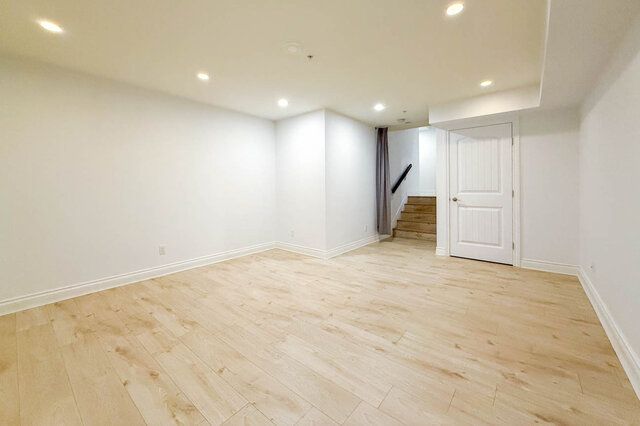 Spacious living room with light hardwood floors and recessed lighting. - 2307 Marine Drive, West Vancouver