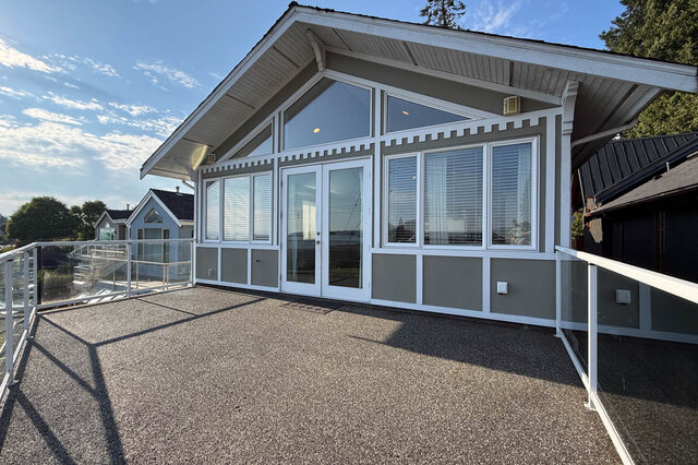 Spacious patio with large windows and glass doors. - 2307 Marine Drive, West Vancouver