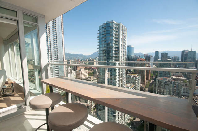 Bright balcony with wooden furniture and stunning city view. - 3301 - 1351 Continental Street, Vancouver Downtown