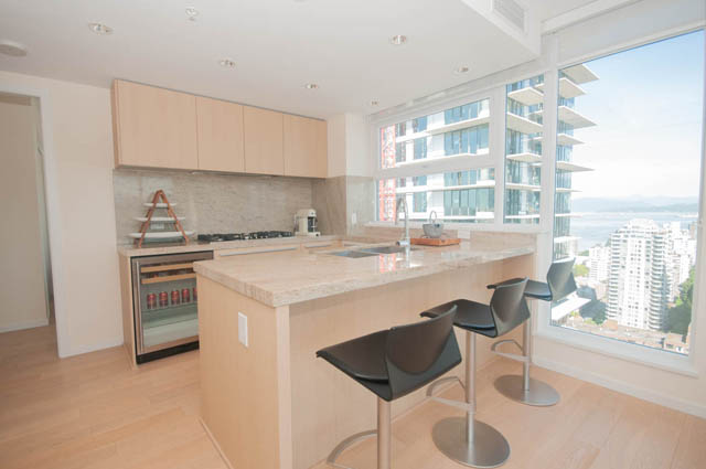 Bright kitchen with granite countertops, hardwood floors, and a city view. - 3301 - 1351 Continental Street, Vancouver Downtown