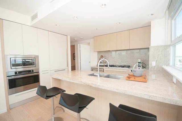 Bright kitchen with modern appliances, granite countertops, and a city view. - 3301 - 1351 Continental Street, Vancouver Downtown