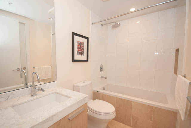 Furnished bathroom with marble countertops and a modern shower setup. - 3301 - 1351 Continental Street, Vancouver Downtown