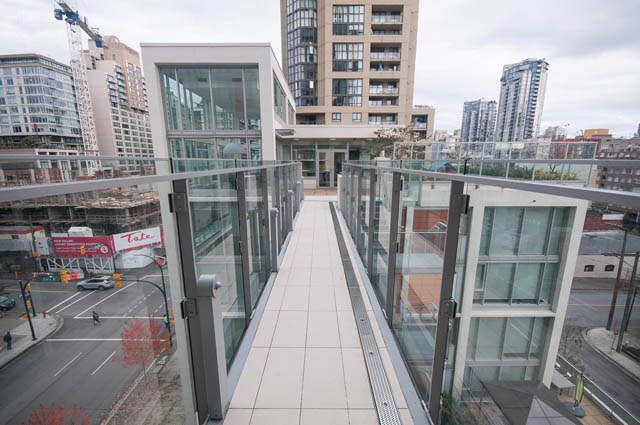 Bright living room with large glass balcony, city view, modern furnishings. - 3301 - 1351 Continental Street, Vancouver Downtown