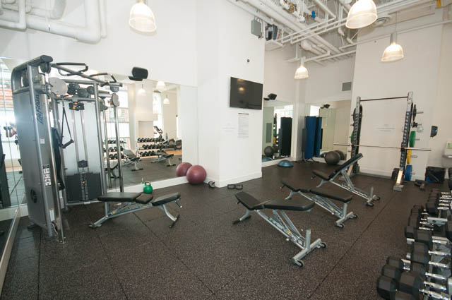 Furnished gym with mirrors, exercise equipment, and weights. - 3301 - 1351 Continental Street, Vancouver Downtown