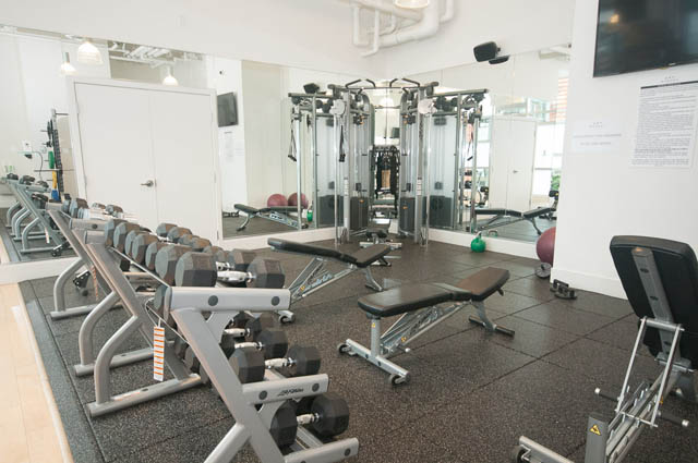 Furnished gym with weight machines and mirrors. - 3301 - 1351 Continental Street, Vancouver Downtown