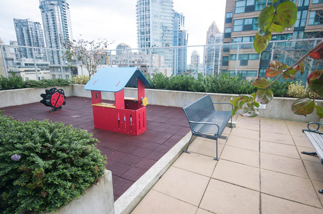 Furnished rooftop patio with city view, red playhouse, and outdoor seating. - 3301 - 1351 Continental Street, Vancouver Downtown